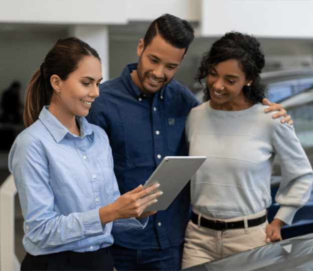 Salesperson looking at tablet with customers